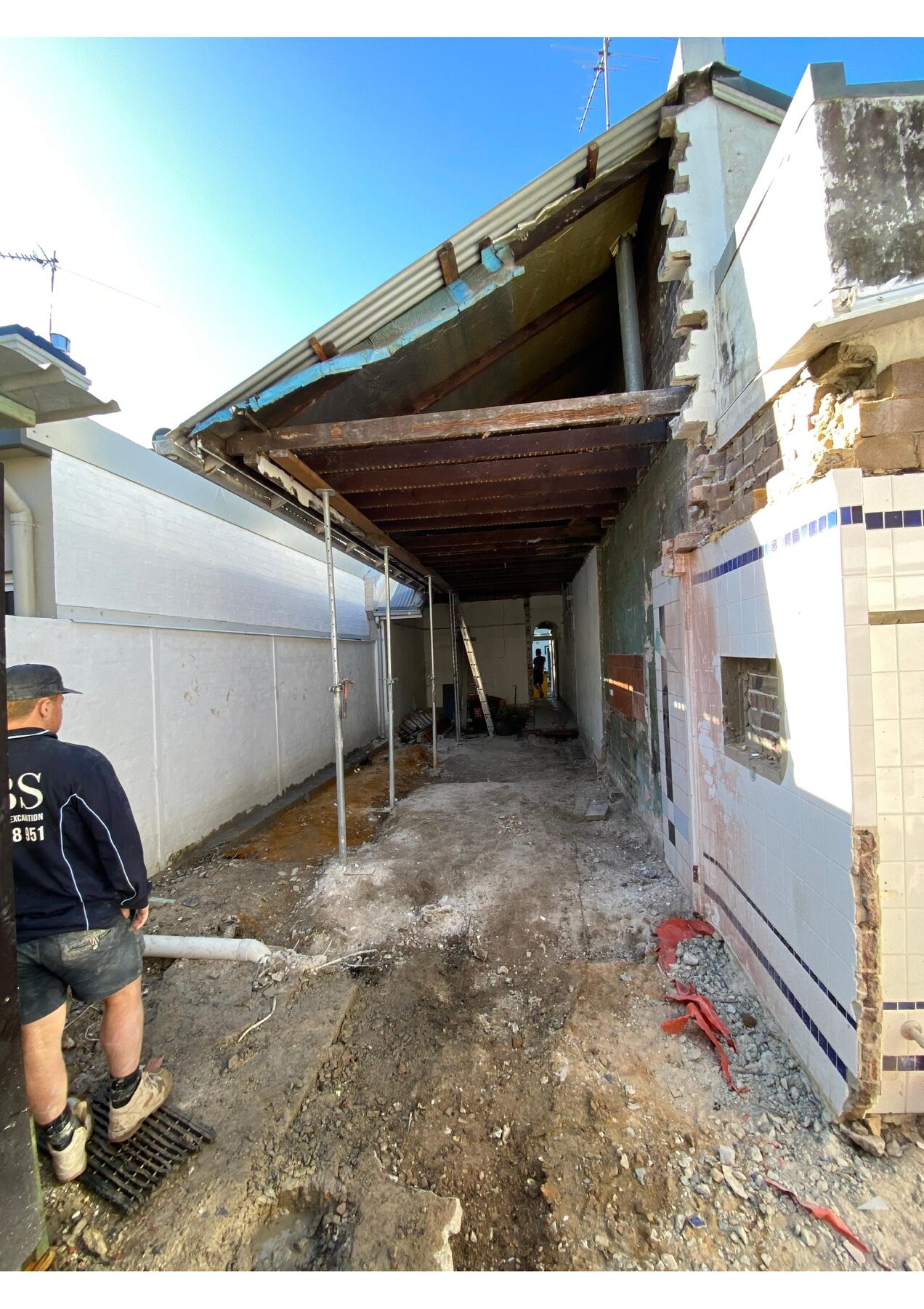 MBS team member inside a Paddington heritage strip-out with Acrow propping and original wall tiles